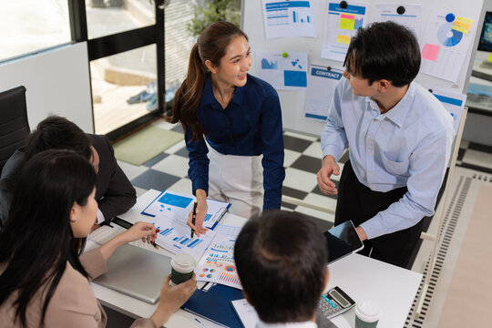 Business, technology and office concept, businessman with laptop, tablet pc computer and papers having discussion in modern office.