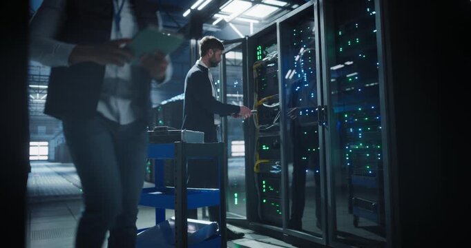 Technician moves a cart through a data center, opens a server rack, and inspects network hardware among rows of servers, equipment maintenance, cable management, a system reliability in a secure