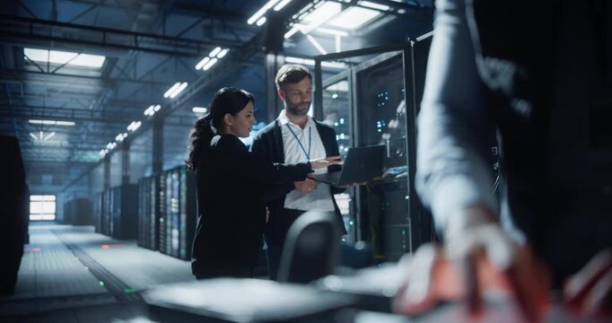 Technician scans hard disk drive with a specialized device in a high-tech data center, secure server device management, network connection checks, saas business infrastructure.