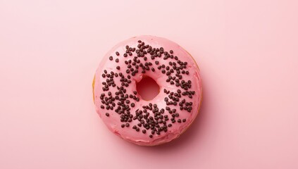 Sweet Treat. A Pink Donut with Chocolate Sprinkles on a Soft Pink Background.