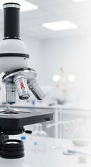 Microscope with red ribbon symbol on lens in lab, concept for aids awareness day.