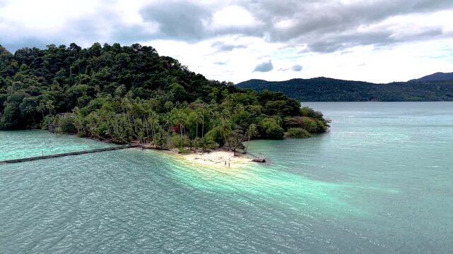 This tropical paradise features lush greenery and clear turquoise waters, showcasing the beauty of Phrao Nok Island Koh Chang. Perfect for nature lovers and adventure seekers looking for tranquility.