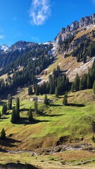 A beautiful mountain scene in the Bernese Oberland, Switzerland, showing a clear view of an impressive mountain range illuminated by warm autumn light