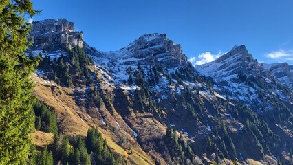 A breathtaking alpine scene in the Bernese Oberland, Switzerland, featuring the Niederhorn mountain chain surrounded by golden autumn colors