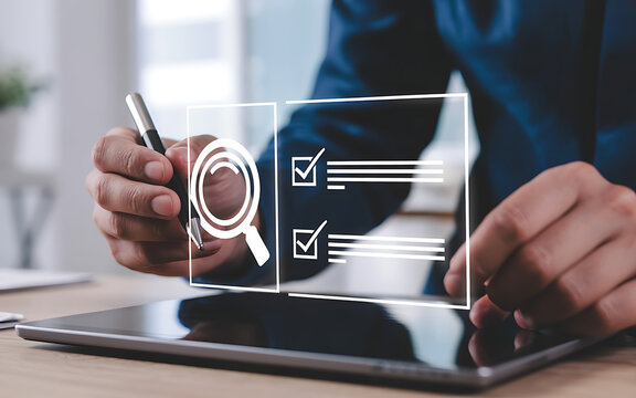 Businessman using a digital tablet with a holographic interface showing a checklist and magnifying glass, representing online research and task management