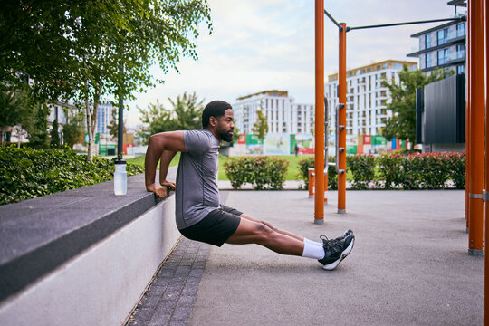 Determined Man Seeks Weight Loss Goals While Working Out Outdoors At Gym Park