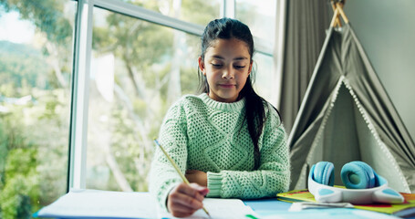 Homework, learning and notebook with girl student at desk n home for development or growth. Education, school study and writing with child learner in apartment for assessment, knowledge or solution