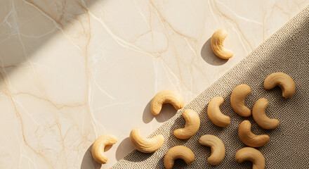 scattered cashew nuts on a light beige marble floor