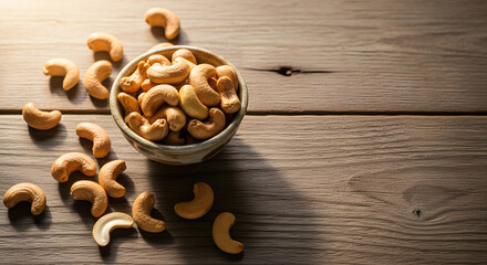Ceramic bowl filled with cashew nuts on rustic wooden table
