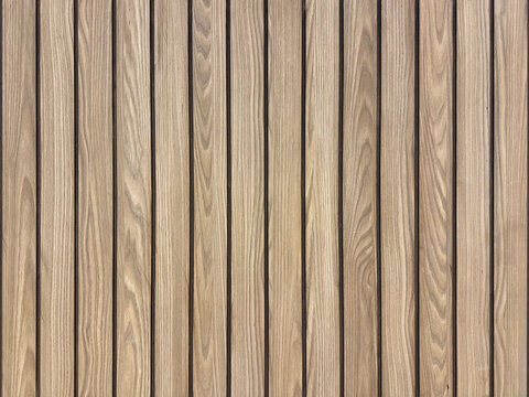Brown oak wood fluted panel or fluted strips, rustic wood, seamless background texture.