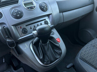 Exploring the interior of a compact vehicle highlighting the gear shifter and dashboard controls in a modern city setting
