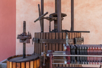 Old olive oil press made of wood and metal, featuring large screw mechanisms and gears once used for traditional olive pressing