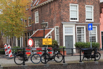 Leiden Street View with Parked Bicycles, Autumn Foliage and Brick House Facades, Netherlands © Monica