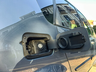 Discovering the convenience of electric vehicle charging at a city location during late afternoon...