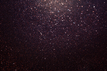 Macro glitter texture curving inside spherical shape, focus follows arc with sharp sparkles below while inner part fades into soft abstract blur