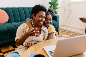 Daughter and her mom enjoying movie time at home
