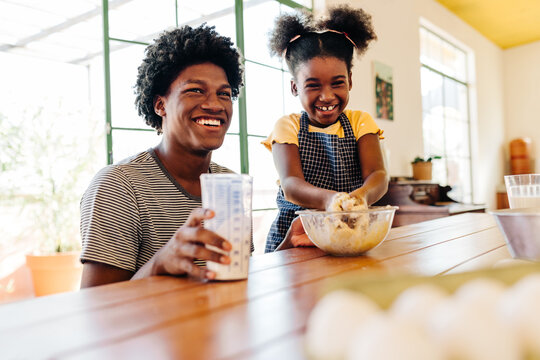 Happy siblings Making Brazilian cornmeal cake together at home