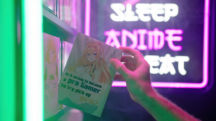 Hand pick a manga comic with cute anime girl from shelf with futuristic neon sign Eat Sleep Anime Repeat in background