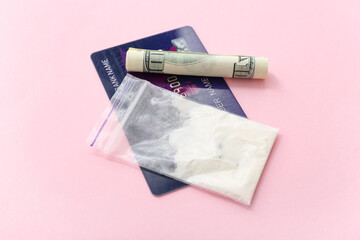 Drugs, credit card and money on pink background