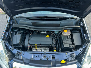 Fototapeta premium Exploring the intricate details of a modern car engine during a sunny afternoon under the hood