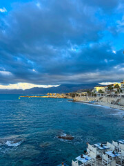 Breathtaking coastal view captures the tranquility of the sea and the soft glow of twilight in a picturesque shoreline setting