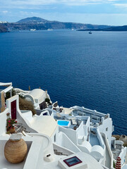 Breathtaking views of white architecture and deep blue waters in Santorini, Greece during a clear sunny day