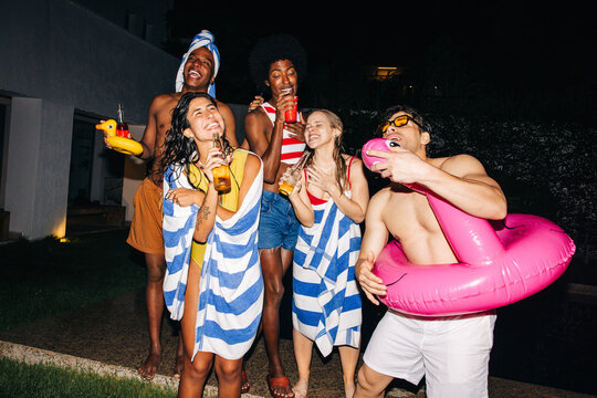 Friends pool party with inflatables and drinks