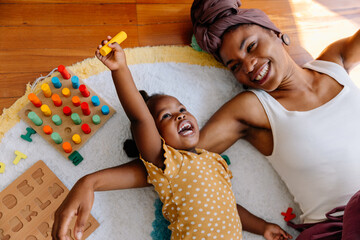 Mother and child playing with toys at home