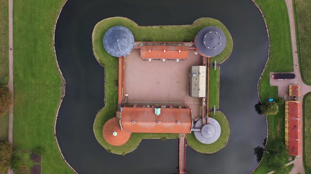 Aerial view of Landskrona Citadel surrounded by a moat and vibrant green lawns, creating a striking contrast of colors and textures, Landskrona, Scania County, Sweden.
