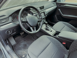 Modern car interior showcasing stylish design and advanced features in a sleek sedan on a sunny...
