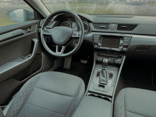 Modern car interior showcasing sleek design and advanced technology in a rainy weather setting