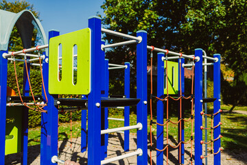 Colorful playground structure invites children to explore and play in a sunny park setting during a...