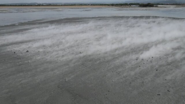 Aerial view of the parched landscape, with dust blowing across the dry terrain creating a hazy atmosphere, Yogyakarta, Yogyakarta, Indonesia.