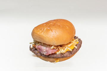 Beef burger with homemade guacamole, sliced ​​jalapeños, and Monterey Jack cheese on a corn bun