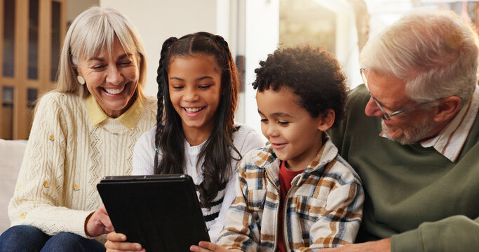 Tablet, relax and grandparents with siblings on sofa in home for watching movie, series or show. Happy, digital technology and senior people with kids for streaming film together in living room.