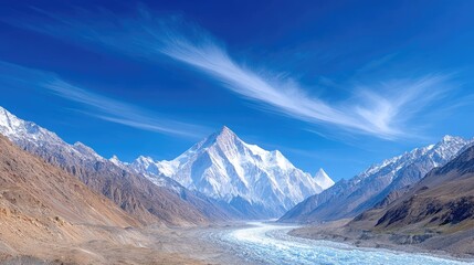 Fototapeta premium Majestic Snow Capped Mountain Peaks Under a Vibrant Blue Sky With Wispy Clouds And A Glacial Valley Below During Daytime
