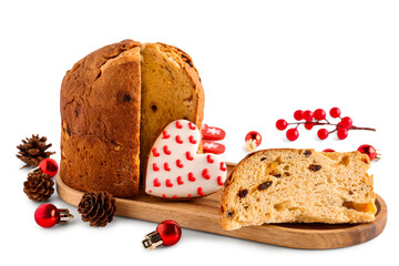 Wooden tray with cut Panettone, cookie, cones and Christmas balls on white background