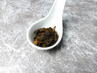 Dried tea leaves on white bowl