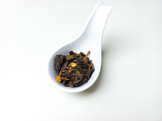 Dried tea leaves on white bowl