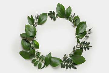 Frame made of different fresh green leaves on grey background