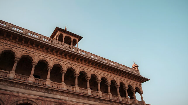 Detailed ancient palace facade, intricate archways glowing in golden light, a clear depiction of historical grandeur and timeless craftsmanship - Powered by Adobe