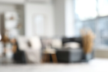 Stylish interior of living room with grey sofa, blurred view