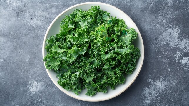 Green kale juice smoothie with fresh kale leaves in a white plate on a gray background - Powered by Adobe