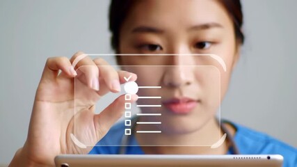 Asian nurse in blue uniform interacting with a hologram checklist, holding a white pill and a tablet on a gray background, symbolizing modern healthcare technology. - Powered by Adobe