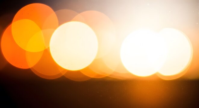 Warm glowing abstract bokeh light circles creating a radiant background