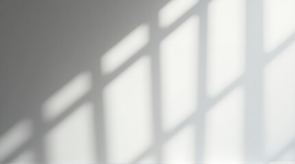 Obraz premium Natural sunlight casts geometric shadows across a clean, modern minimalist wall, creating an airy, tranquil, and sophisticated ambiance perfect for design.