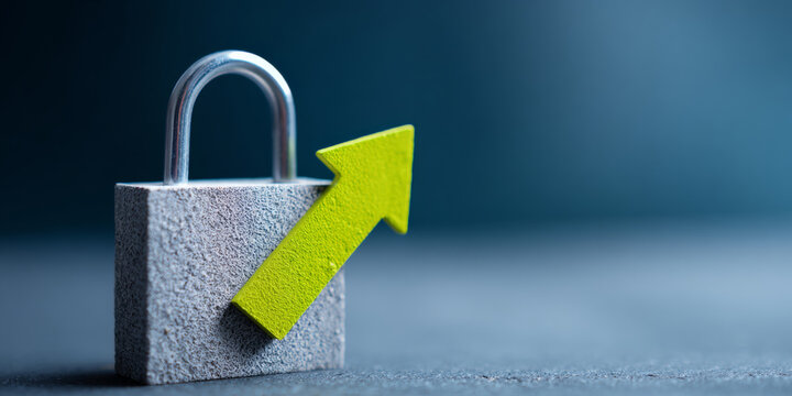 Close-up of a textured gray padlock with a bright green upward arrow symbolizing security growth and protection on a blurred blue background