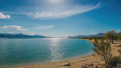 Obraz premium Deserted lakeshore with water and sky, evoking summer travel and nature's tranquility