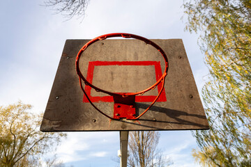 A basketball hoop on an outdoor sports ground