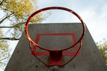 A basketball hoop on an outdoor sports ground